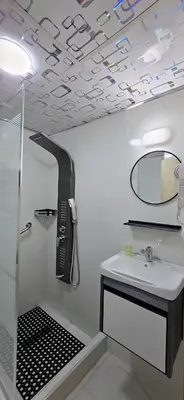 a bathroom with a sink and a phone on the ceiling at Balcony Hotel in Amman