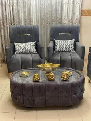 a living room with a couch and a coffee table at الرمثا هوتل in Ar Ramthā