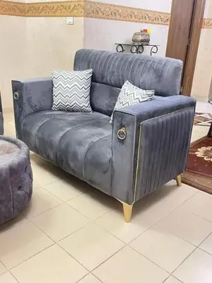 a blue leather couch sitting in a living room at الرمثا هوتل in Ar Ramthā