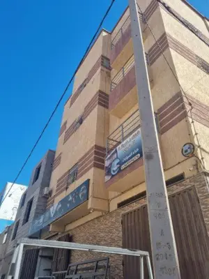 a tall building with a sign on the side of it at الرمثا هوتل in Ar Ramthā