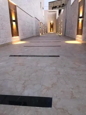 an empty hallway of a building with lights on at الرمثا هوتل in Ar Ramthā