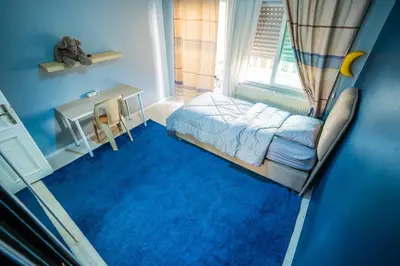 a bedroom with a bed and a desk and a window at 3 Bedrooms Cozy Apartment Prime Location Walk Anywhere شقة مفروشة واسعة شارع الجاردنز in Amman