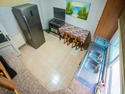 an overhead view of a kitchen with a table and a refrigerator at 3 Bedrooms Cozy Apartment Prime Location Walk Anywhere شقة مفروشة واسعة شارع الجاردنز in Amman