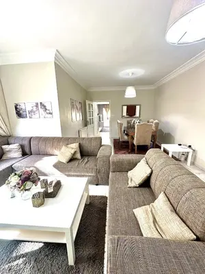 a living room with two couches and a table at 3 Bedrooms Cozy Apartment Prime Location Walk Anywhere شقة مفروشة واسعة شارع الجاردنز in Amman