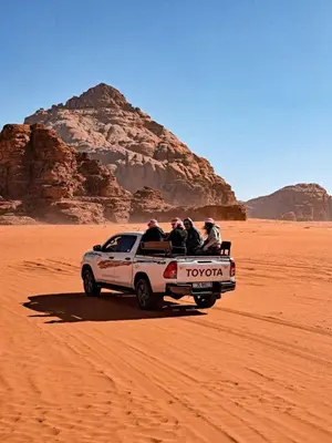 a group of people in the back of a truck in the desert at Wildlife Camp in Disah