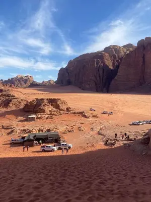a group of vehicles parked in the desert at Wildlife Camp in Disah