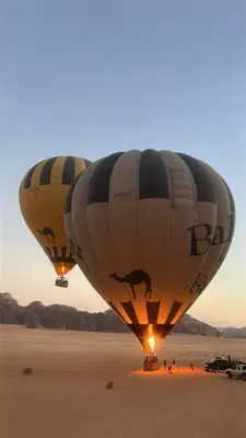 two hot air balloons flying over the desert at Wildlife Camp in Disah