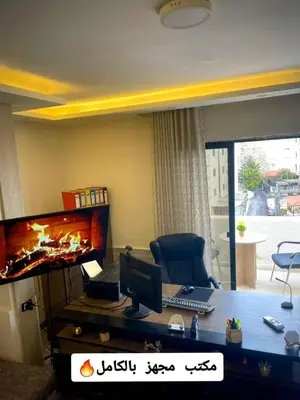 a office with a desk with a computer on it at Falcon Real Estate in Amman