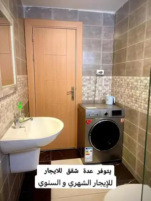 a bathroom with a sink and a washing machine at Falcon Real Estate in Amman