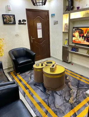 a lobby with a waiting room with a table and a chair at Falcon Real Estate in Amman