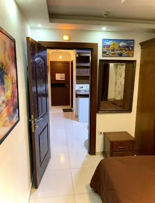 a room with a hallway with a door and a kitchen at Falcon Real Estate in Amman