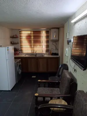a kitchen with a sink and a refrigerator at شقة الراحة والسعادة economic comfortable flat first floor in Amman