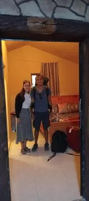 a man and two girls standing in a room at Dana Valley Tourism Hotel in Dana