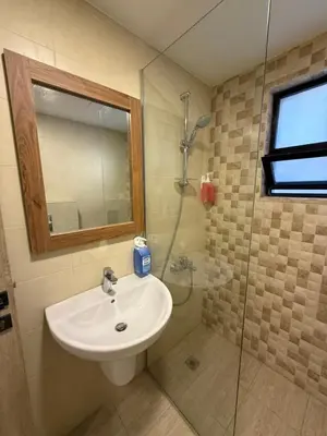 a bathroom with a sink and a shower at unique 2bedroom at abdoun 007 in Amman