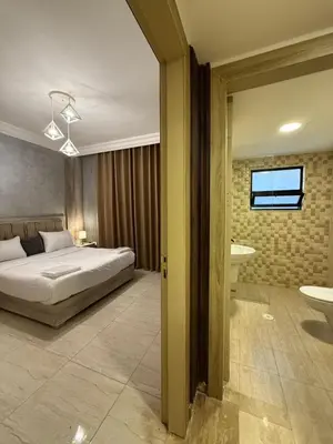 a bedroom with a bed and a bathroom at unique 2bedroom at abdoun 007 in Amman
