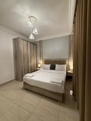 a bedroom with a large white bed in a room at unique 2bedroom at abdoun 007 in Amman