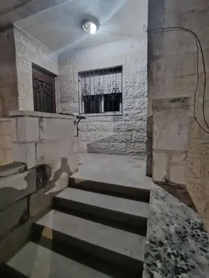 an empty room with stairs and a window at شقة مفروشة مدخل مستقل in Jurf ad Darāwīsh