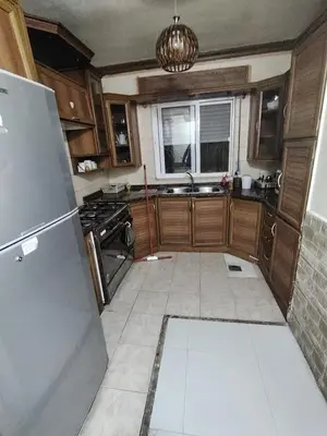 a kitchen with a sink and a refrigerator at شقة مفروشة مدخل مستقل in Jurf ad Darāwīsh