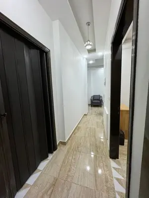 a hallway with white walls and a black door at Seventh circle stay - Cozy &Chic in Amman