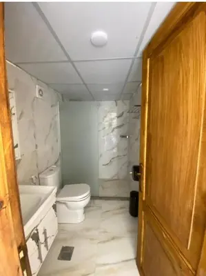 a bathroom with a toilet and a tub and a sink at Rum gate camp Fares in Disah