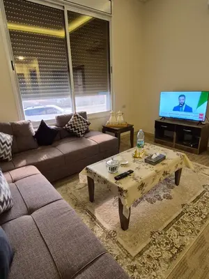 a living room with a couch and a coffee table at Reef Palace - Rihab قصر الريف - رحاب in Al Manshīyah
