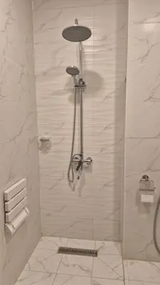 a shower with a glass door in a bathroom at Reef Palace - Rihab قصر الريف - رحاب in Al Manshīyah