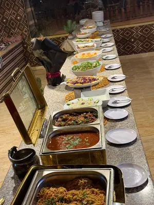 a long buffet of food on a table at Wadi Rum Quiet luxury camp in Wadi Rum