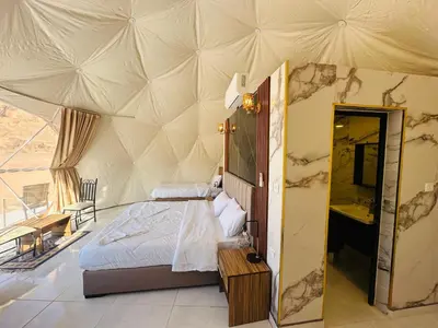 a bedroom with a bed in a tent at Wadi Rum Salman camp in Wadi Rum