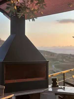 a black stove top on a table with a view of the ocean at منتجع ومزرعة برجيل السد in Ballās