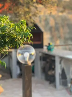 a parking meter in front of a building with a house at منتجع ومزرعة برجيل السد in Ballās