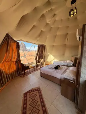 a bedroom with a bed in a tent at Wadi Rum Hala camp in Wadi Rum