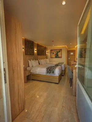 a bedroom with a large bed in a room at Grand Season Hotel in Aqaba
