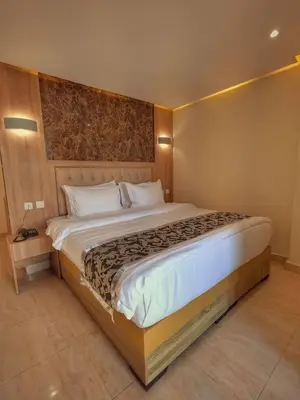 a bedroom with a large bed in a room at Grand Season Hotel in Aqaba