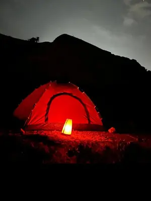 a red tent with a candle in the dark at Dana Hiking Camp - Dana Nature Reserve in Dana