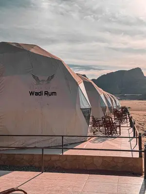 a row of well run tents on the beach at Flora Camp Wadi Rum in Wadi Rum