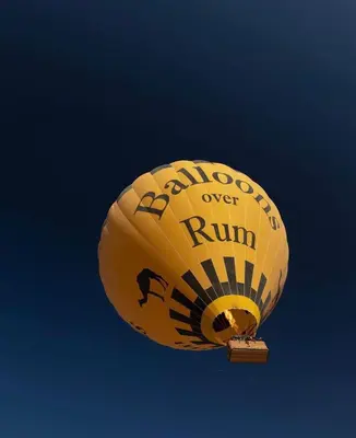 a yellow balloon is flying in the sky at RUM BUBBLES VIEW MARS lUXURY CAMP in Wadi Rum