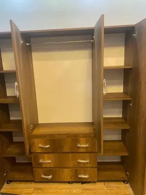 an empty closet with wooden shelves and cabinets at LINCON inn in Aqaba