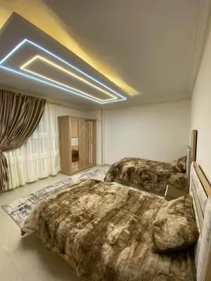 a large room with two beds in it with at LINCON inn in Aqaba