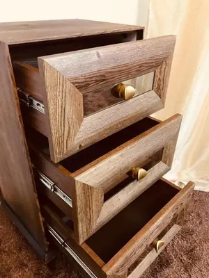 a wooden dresser with three drawers with gold handles at July house in Wadi Musa