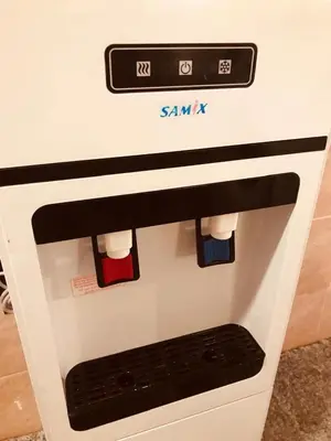a white oven with red and blue socks on it at July house in Wadi Musa