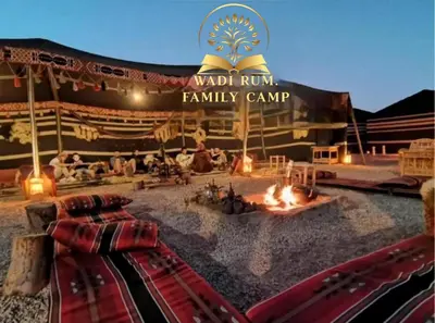 a tent with a fire pit in front of it at RUM FAMiLY BUBBLES &BEDOUIN CAMP in Wadi Rum