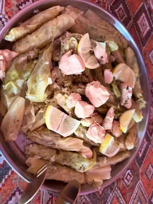 a bowl of food with chicken and vegetables on a table at Wanderlust Jordan Camp in Wadi Rum