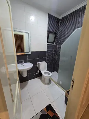 a bathroom with a toilet and a sink at Gardens Complex in Amman