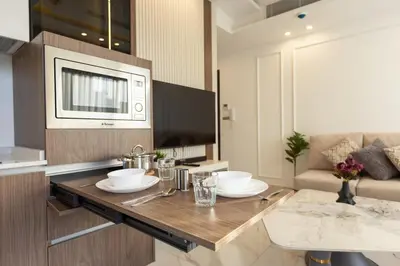 a kitchen with a table with two white dishes on it at Shamsi Apartments 222 in Amman