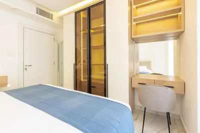a bedroom with a bed and a desk and a chair at Shamsi Apartments 222 in Amman