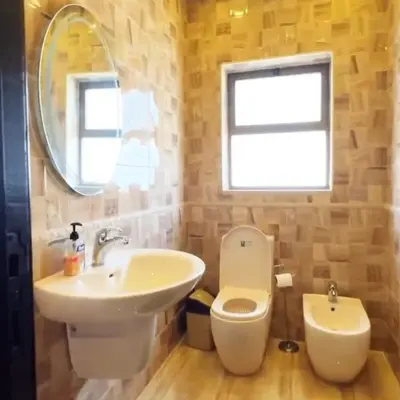 a bathroom with a sink and a toilet and a mirror at Badr in Amman