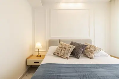 a bedroom with a bed with pillows and a window at Shamsi Apartments 223 in Amman