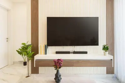 a living room with a tv and a vase with flowers at Shamsi Apartments 223 in Amman