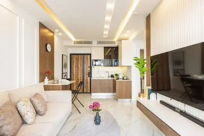 a living room with a couch and a kitchen at Shamsi Apartments 223 in Amman