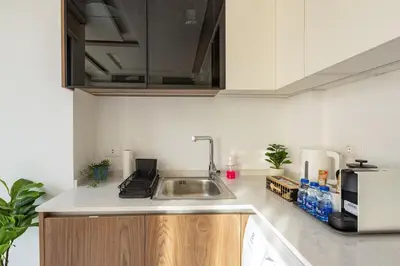 a kitchen with a sink and a microwave at Shamsi Apartments 329 in Amman
